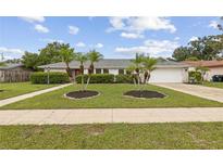 Charming ranch home with landscaped lawn and driveway at 3994 Irma Shores Dr, Orlando, FL 32817