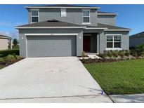 Two story house with attached garage and landscaping at 420 Quarry Rock Cir, Kissimmee, FL 34758