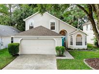 Two-story house with a two-car garage and landscaped lawn at 812 Shell Ln, Longwood, FL 32750