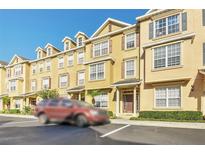 Front view of yellow townhouses with parking at 655 Pensacola Ln, Lake Mary, FL 32746