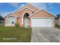 One-story house with two-car garage and light peach exterior at 2108 Shannon Lakes Blvd, Kissimmee, FL 34743