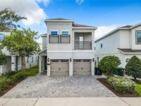 Two-story house with two-car garage and a brick paved driveway at 7702 Graben St, Kissimmee, FL 34747