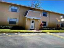 Front view of a two-story apartment building with ample parking at 1613 W Oak Ridge Rd # 1613B, Orlando, FL 32809
