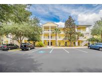 Yellow multi-story building with parking and landscaping at 514 Lucaya Loop # 514, Davenport, FL 33897