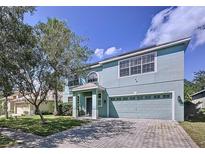 Two story house with a large front yard and driveway at 11121 Sunup Ln, Orlando, FL 32825