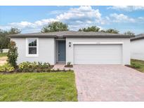 Newly built home with grey exterior and two-car garage at 2342 White Tail St, Davenport, FL 33837