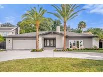Stunning ranch home with circular driveway and palm trees at 238 E Lakeshore Dr, Clermont, FL 34711