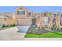 Two-story house with attached garage and landscaping at 7876 Oak Reflection Loop, Davenport, FL 33837