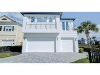 Modern two-story home with two-car garage and balcony at 1561 Corolla Ct, Reunion, FL 34747