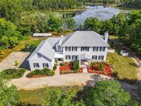 Two story house with a landscaped yard and lake view at 226 Mitnik Dr, Deltona, FL 32738