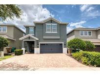 Two-story house with gray siding and a double-car garage at 420 Lasso Dr, Kissimmee, FL 34747