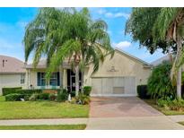 One-story house with palm trees, brick driveway, and lush landscaping at 2366 Prairie Dunes, Clermont, FL 34711