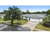 Single story home with white exterior and a two-car garage at 115 Marcy Blvd, Longwood, FL 32750