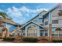 Charming blue two-story building with brick accents at 2749 Poinciana Blvd # 21, Kissimmee, FL 34746