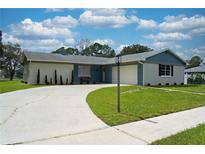 Charming ranch home with a curved driveway, landscaped yard, and neutral exterior at 2142 Hainlin Ct, Deltona, FL 32738