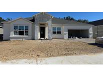 New construction home with gray siding, two-car garage, and landscaping to be installed at 329 Lady Palm St, Apopka, FL 32703