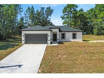 New construction home with a large driveway and backyard at 161 Marion Oaks Trail, Ocala, FL 34473
