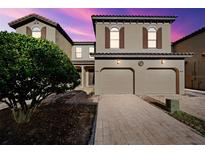 Two-story townhome with two-car garage and landscaping at 8091 Brooksville Dr, Davenport, FL 33896