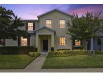 Two-story townhome with landscaping and nighttime lighting at 1209 Seburn Rd, Apopka, FL 32703