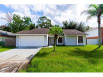 Charming single-story home with a two-car garage and well-maintained lawn at 709 Del Rio Way, Kissimmee, FL 34758