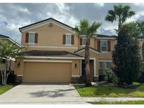 Two story house with a two car garage at 5294 Wildwood Way, Davenport, FL 33837