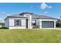 Modern one-story home with gray garage door at 15701 Sw 23Rd Court Rd, Ocala, FL 34473