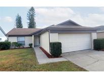 Charming single-story home with attached garage and landscaped front yard at 1050 Abell Cir, Oviedo, FL 32765