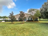 One-story home with a landscaped yard at 24341 Milford Dr, Eustis, FL 32736