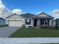 One-story house with a two-car garage and landscaped lawn at 3263 Roseville Dr, Apopka, FL 32712