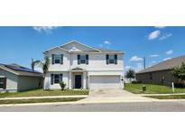 Two-story house with attached garage, and dark shutters at 196 Taft Dr, Davenport, FL 33837