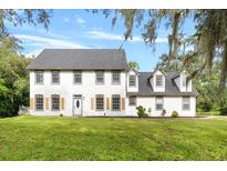 Two story house with shutters and lawn at 12200 Treetop Ct, Orlando, FL 32832