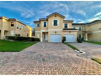 Two-story home with a two-car garage and well-maintained landscaping at 1431 Pacific Rd, Poinciana, FL 34759