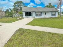 Cozy one-story home with a well-maintained lawn and a paved driveway at 3194 Mapleshade St, Deltona, FL 32738