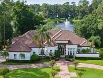 Luxury home with lake view, tile roof, and circular driveway at 256 New Gate Loop, Lake Mary, FL 32746