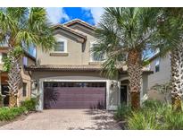 Two story house with a double garage and palm trees at 8869 Rhodes St, Kissimmee, FL 34747
