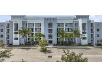 Modern apartment building with ample parking and lush landscaping at 4751 Clock Tower Dr # 105, Kissimmee, FL 34746