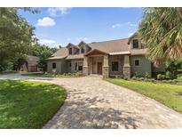 Beautiful two-story home with stone accents and a large driveway at 1041 Cottontail Ln, Maitland, FL 32751