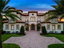 Elegant two-story home with a grand entrance and manicured landscaping at 25602 Grandview Pointe, Sorrento, FL 32776