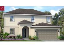 Two-story house with light beige siding, a two car garage, and landscaping at 2260 Sirena Ln, Mount Dora, FL 32757