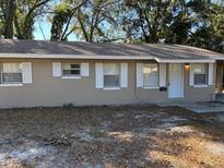 Tan single story house with white trim and a small front yard at 5146 Liming Ave, Orlando, FL 32808