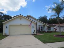 Single-story home with attached garage and landscaped yard at 11540 Sandy Hill Dr, Orlando, FL 32821