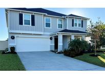 Two-story house with gray siding, white garage door, and landscaping at 2346 Upland Ln, Apopka, FL 32712