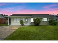 Charming ranch-style home with a well-manicured lawn at 106 Oregon Ave, Saint Cloud, FL 34769