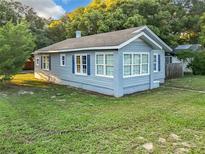 Charming blue house with large windows and yard at 1628 S Grove St, Eustis, FL 32726