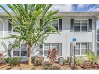 Light blue building exterior with gray shutters and landscaping at 4878 Conway Rd # 91, Orlando, FL 32812