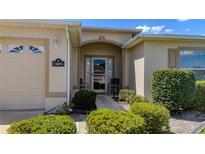 House exterior featuring a welcoming front door and landscaping at 15692 Sw 16Th Ter, Ocala, FL 34473