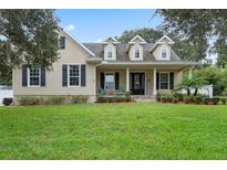 Two-story house with neutral siding and manicured lawn at 70 Millholland St, Oakland, FL 34760
