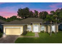 One-story home with two-car garage and landscaped yard at 130 Golf Vista Cir, Davenport, FL 33837