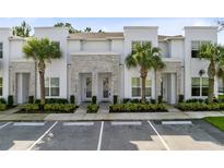 Modern three-unit building with stone accents and palm trees at 17204 Blessing Dr, Clermont, FL 34714