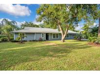 Ranch style home with lush lawn and mature trees at 235 Oakdale St, Windermere, FL 34786